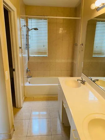 a bathroom with a tub sink and a mirror