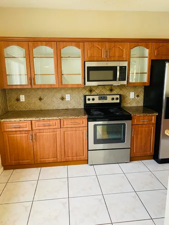 a kitchen with stainless steel appliances a stove a microwave and sink
