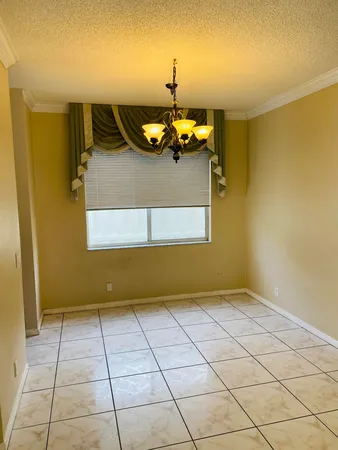 a view of a livingroom with an empty space and a window