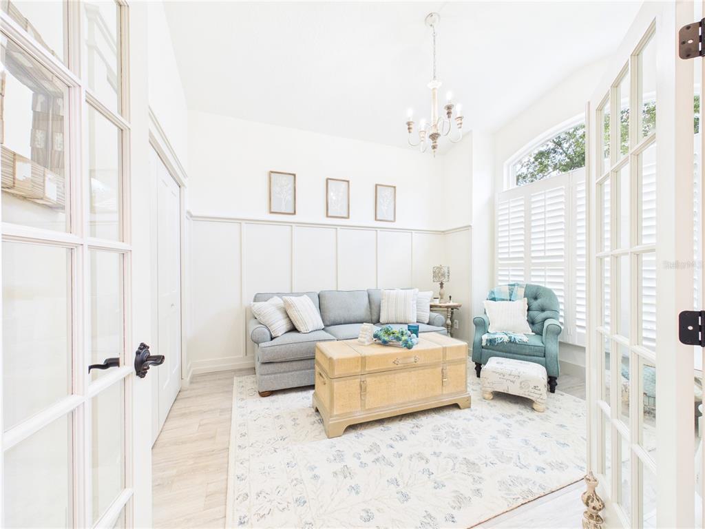 426 Long Cove Road Ormond Beach, FL 32174 - Photo 5 of 73 a living room with furniture and a chandelier