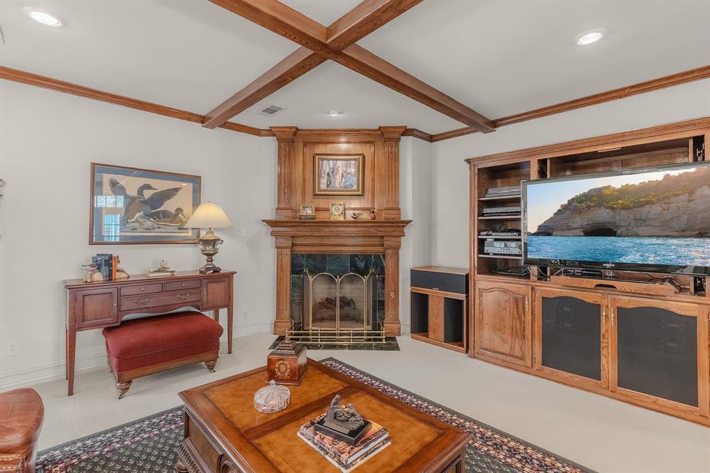 1 Willow Ridge Road Greenville, TX 75402 - Photo 16 of 38 a living room with furniture a flat screen tv and a fireplace
