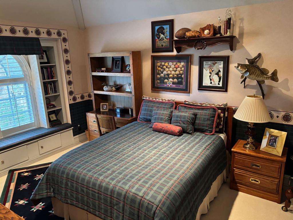1 Willow Ridge Road Greenville, TX 75402 - Photo 23 of 38 a bedroom with a bed a dresser and book shelf