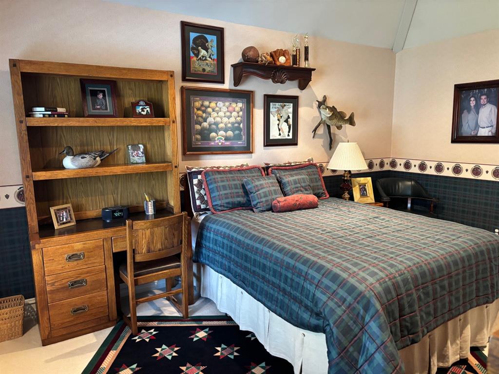 1 Willow Ridge Road Greenville, TX 75402 - Photo 25 of 38 a bedroom with a bed and wooden floor