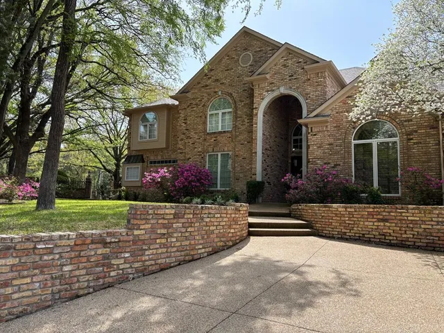 a view of house with outdoor space and garden