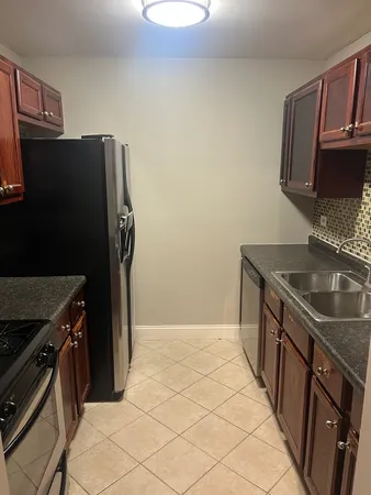 a kitchen with stainless steel appliances granite countertop a refrigerator and a stove