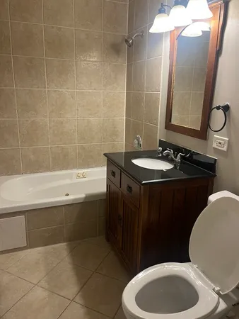 a bathroom with a sink a toilet and bathtub