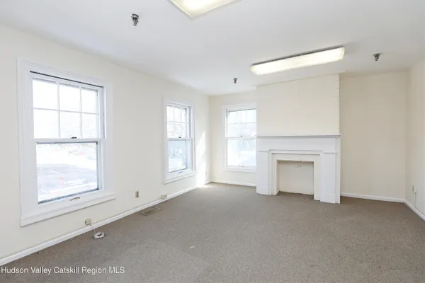an empty room with windows and closet