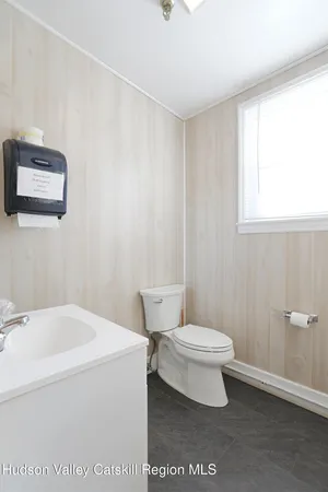 a white toilet sitting next to a bathroom sink