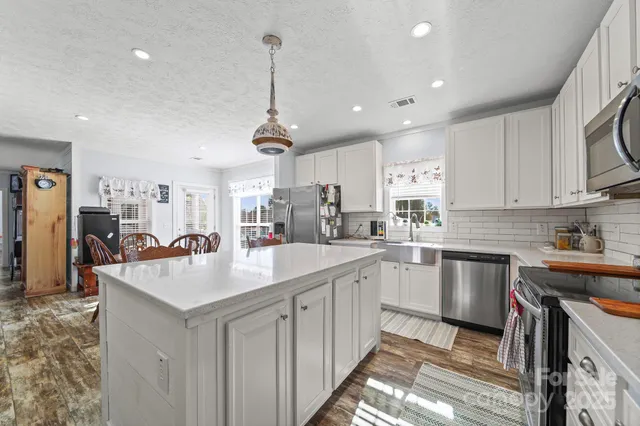 a kitchen with appliances cabinets and a sink