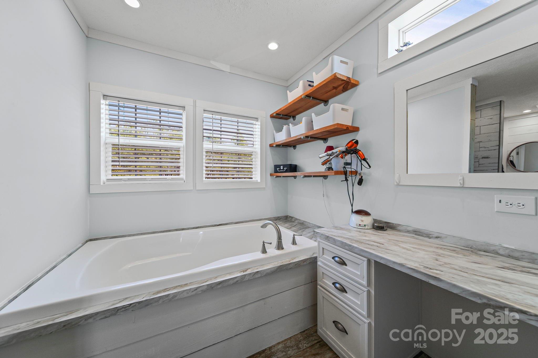 6179 Steen Road Jefferson, SC 29718 - Photo 13 of 26 a bathroom with a bathtub and a sink