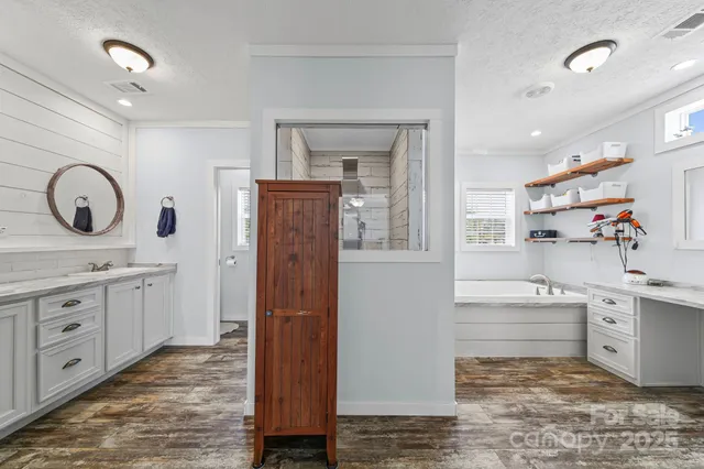 a room with white cabinets and sink