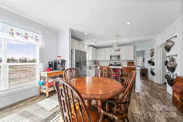 a view of a dining room with furniture and a window