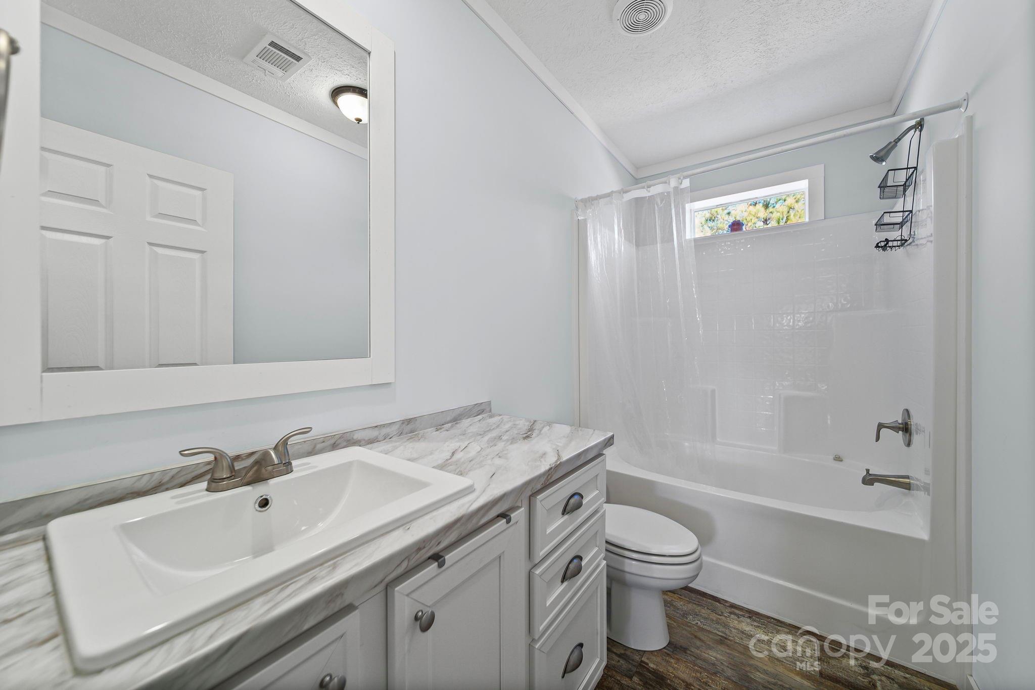 6179 Steen Road Jefferson, SC 29718 - Photo 18 of 26 a bathroom with a sink a toilet and shower