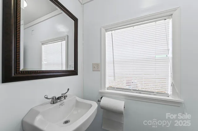 a bathroom with a sink and a window