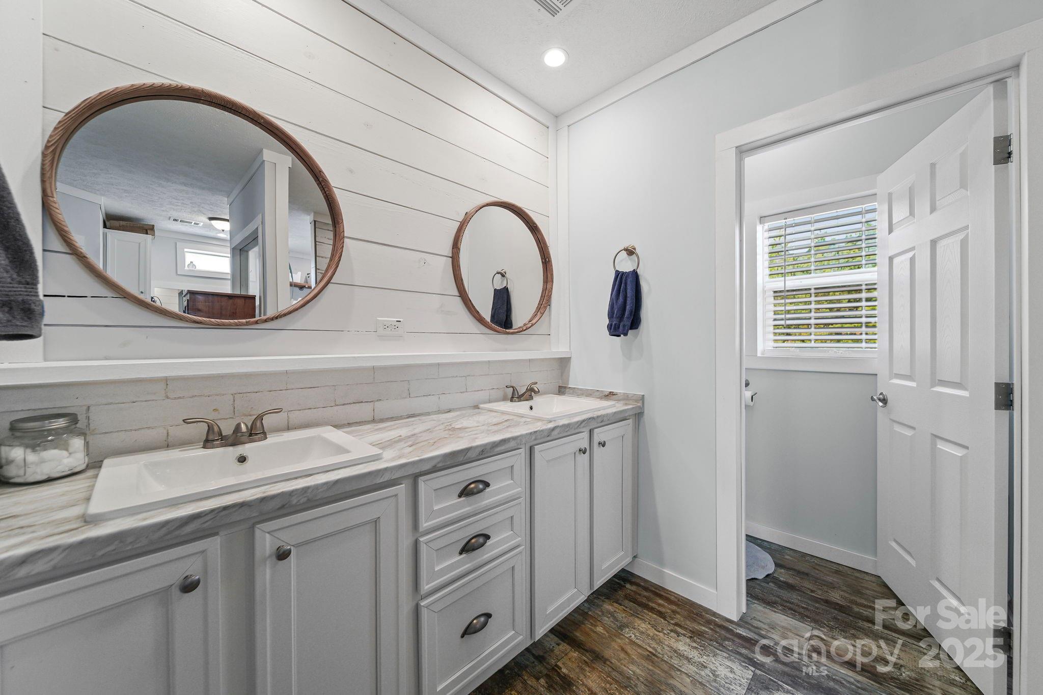 6179 Steen Road Jefferson, SC 29718 - Photo 4 of 26 a bathroom with a granite countertop double vanity sink and a mirror