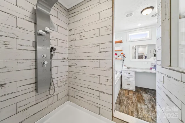 a bathroom with a bathtub and shower