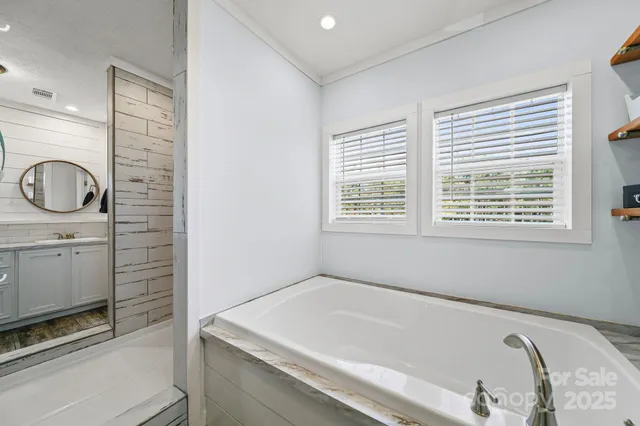 a bathroom with a bathtub and a window