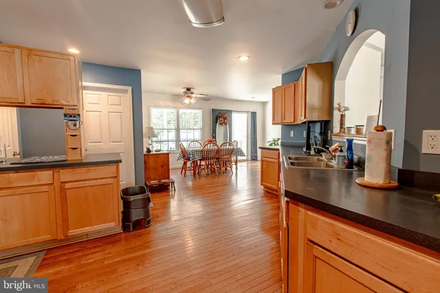 a kitchen with stainless steel appliances granite countertop counter space a sink and a refrigerator