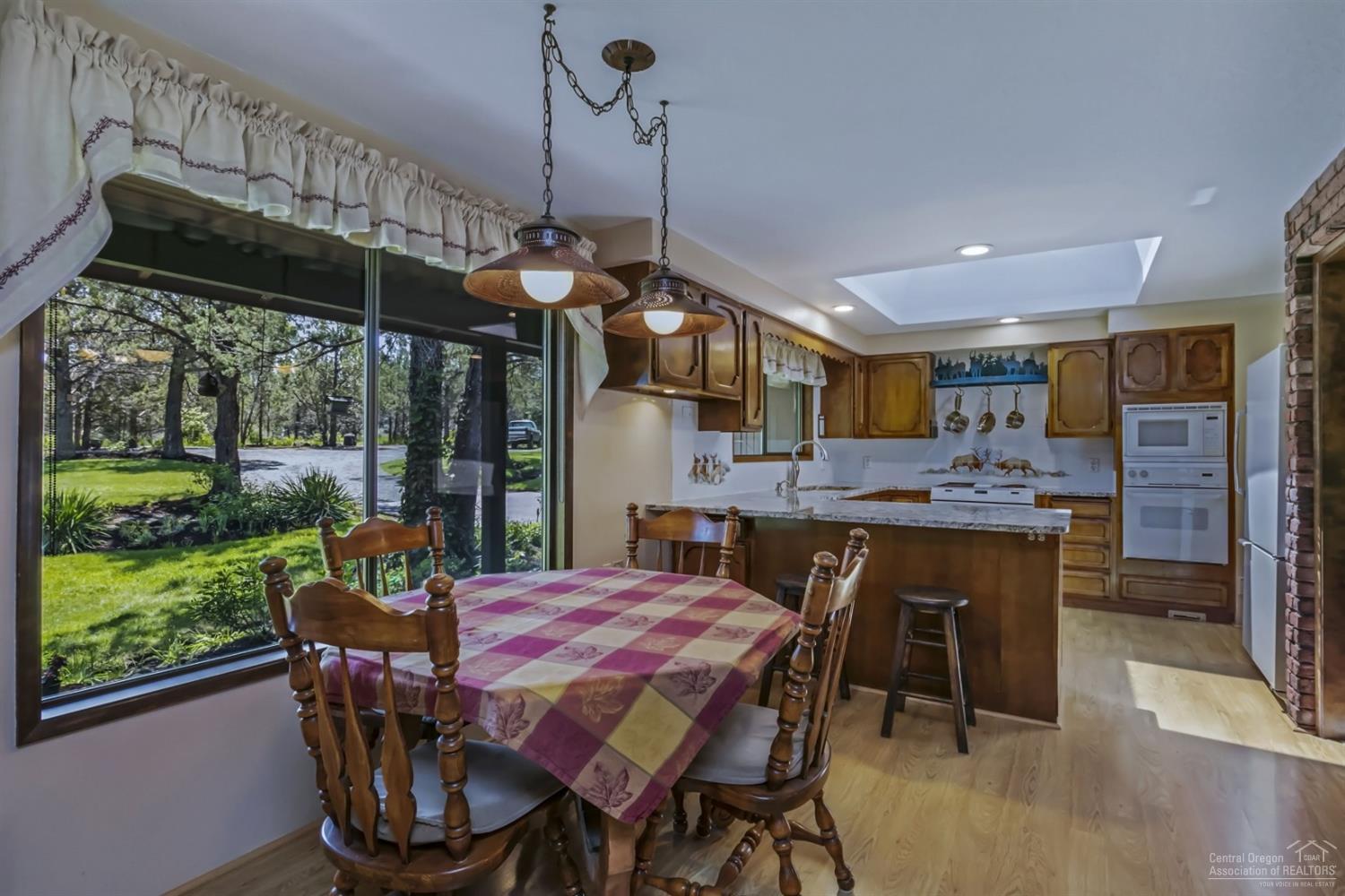 19435 Dayton Road Bend, OR 97703 - Photo 5 of 25 a view of a dining room with furniture window and outside view
