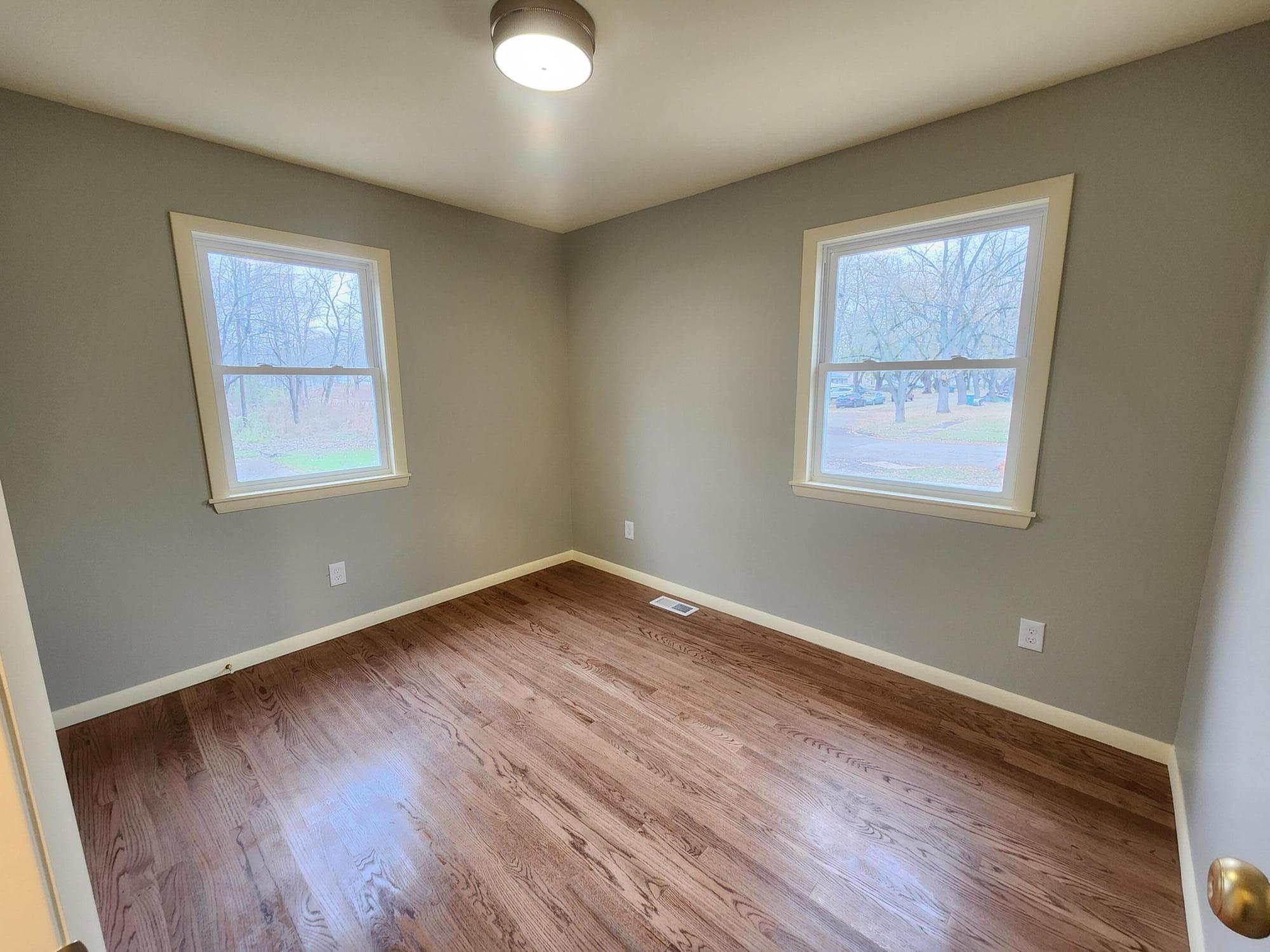 5049 Indiana Place Gary, IN 46409 - Photo 13 of 23 a view of an empty room with wooden floor and a window