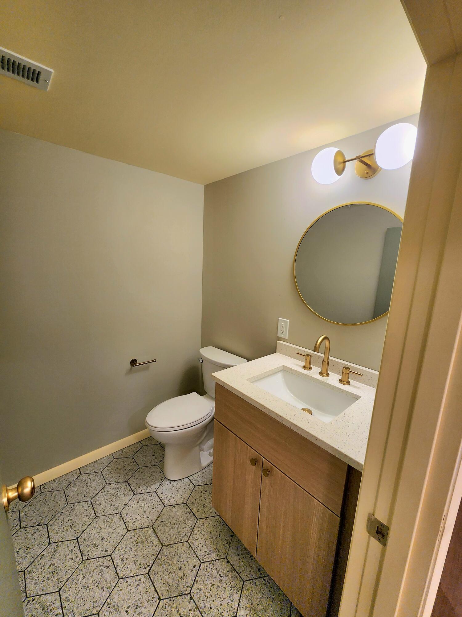 5049 Indiana Place Gary, IN 46409 - Photo 18 of 23 a bathroom with a toilet sink and mirror