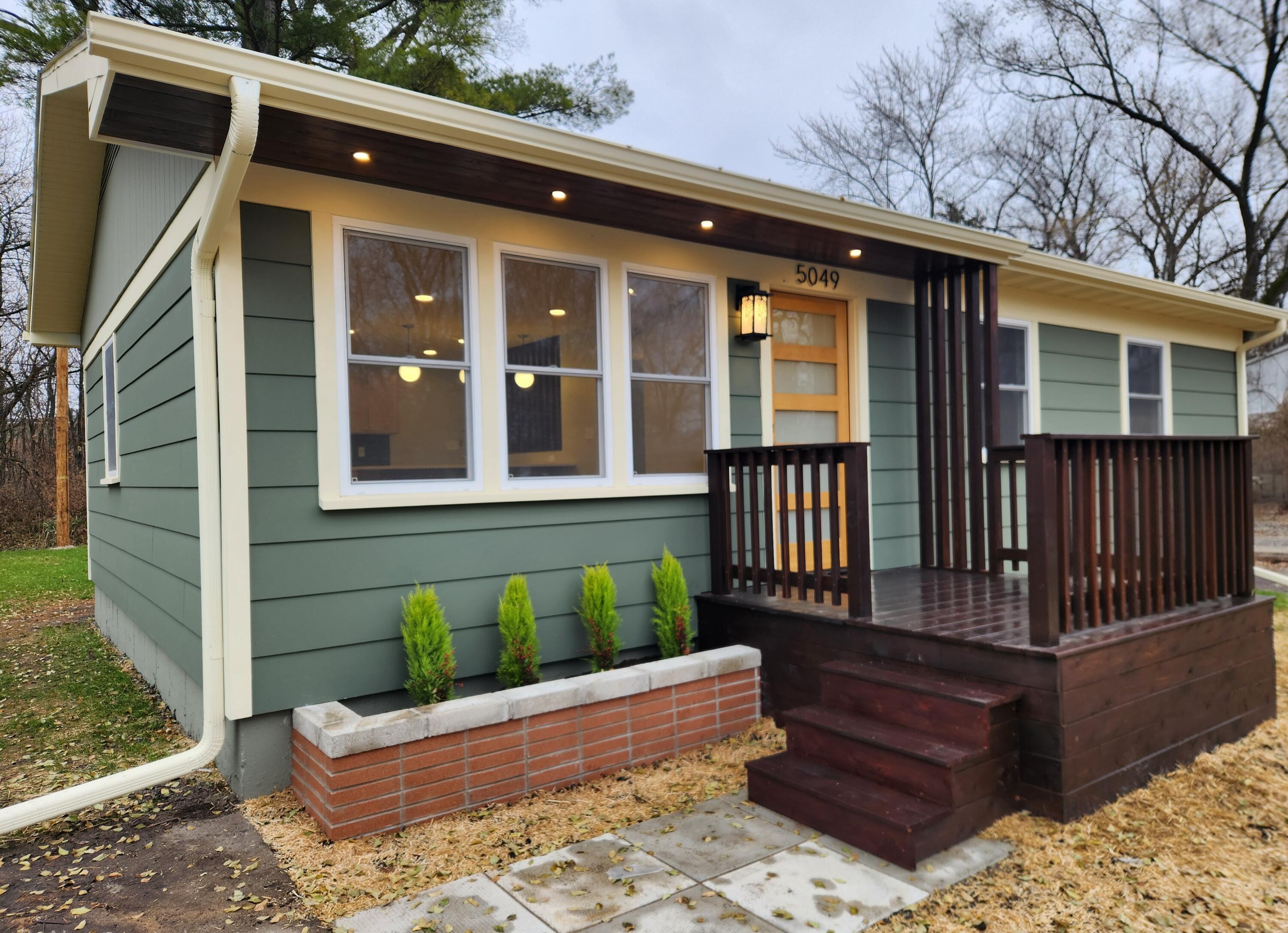 5049 Indiana Place Gary, IN 46409 - Photo 3 of 23 a view of a house with a wooden deck and furniture