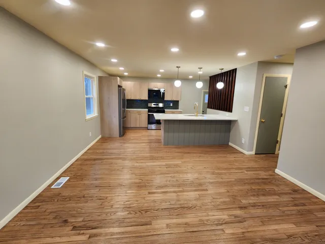 a view of a room with furniture and wooden floor
