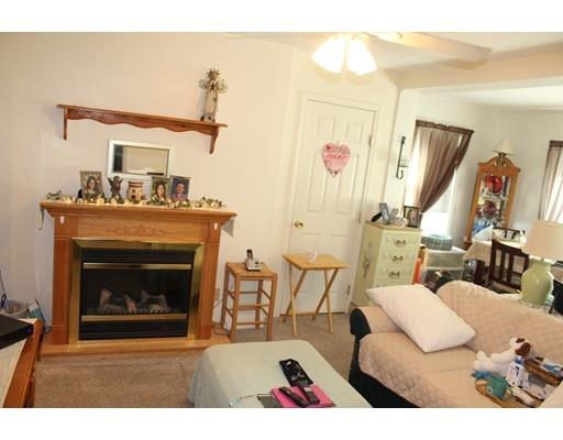 46 Manatee Road Weymouth, MA 02189 - Photo 21 of 29 a living room with furniture a fireplace and a flat screen tv