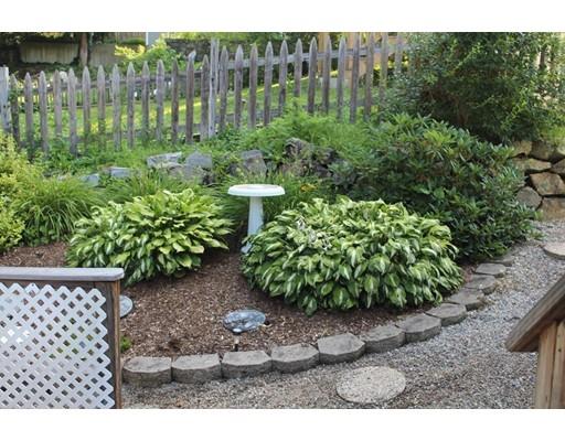 46 Manatee Road Weymouth, MA 02189 - Photo 8 of 29 a view of a garden with a bench