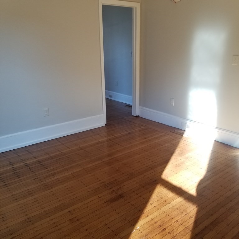 82 Temple Street Springfield, MA 01105 - Photo 9 of 14 a view of an empty room and wooden floor