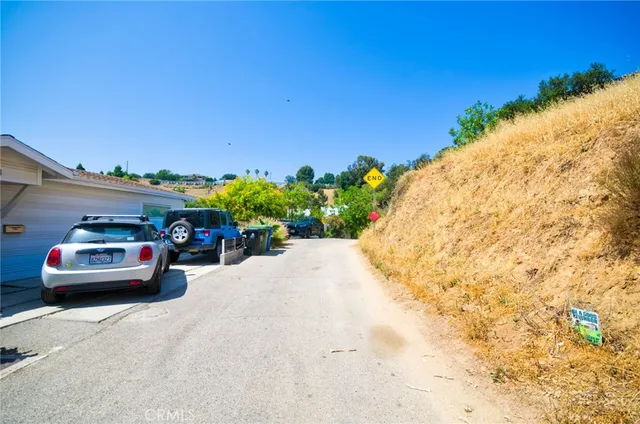 an aerial view of a house with a yard and lake view