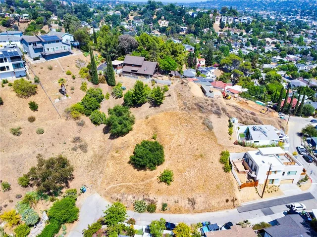 an aerial view of a houses with a street