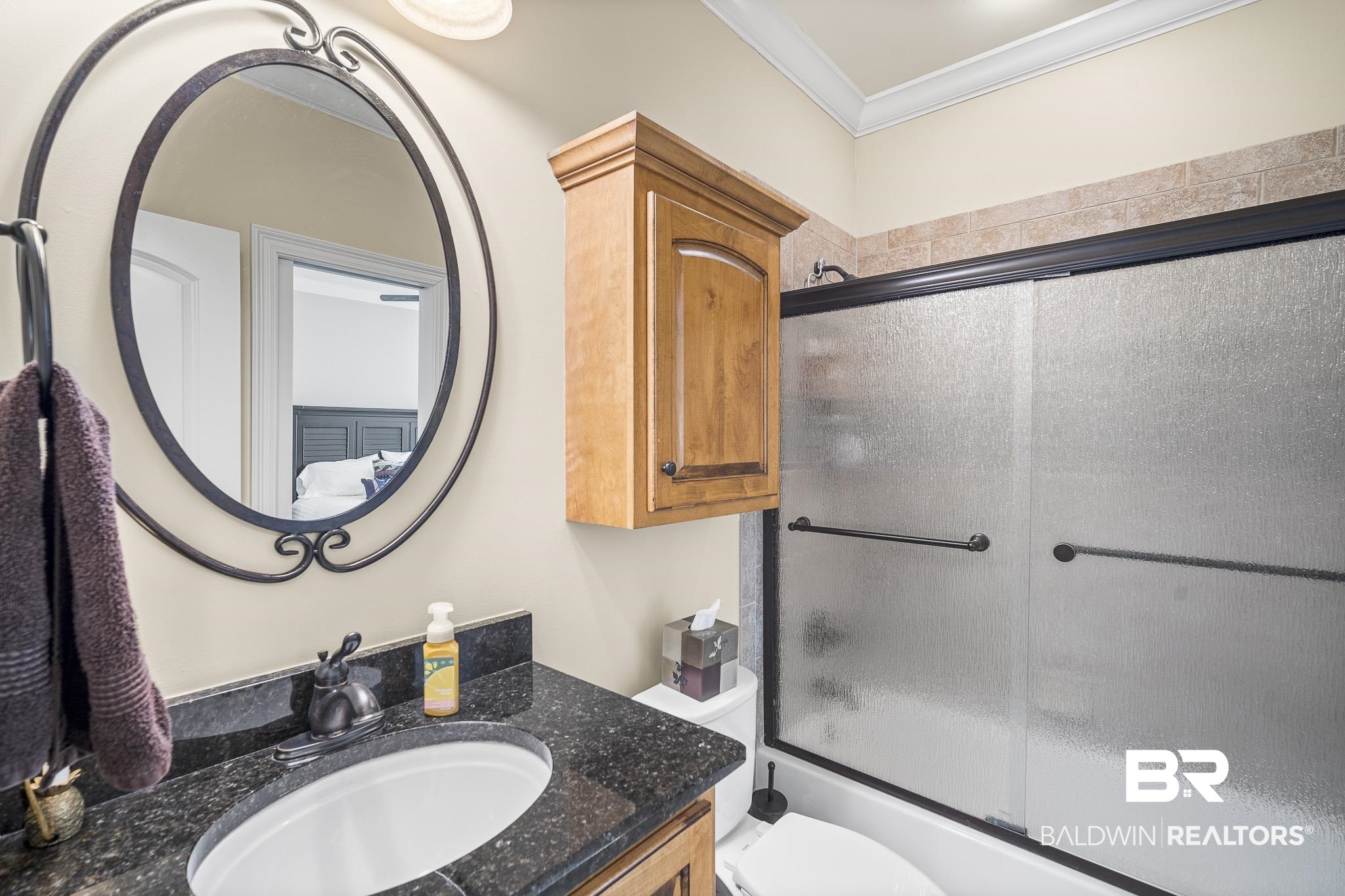 7090 Carson Lane Daphne, AL 36527 - Photo 22 of 37 Full bathroom with vanity, toilet, shower / bath combination with glass door, and ornamental molding