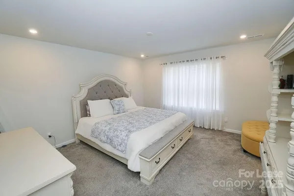 a spacious bathroom with a granite countertop double vanity sink mirror and shower