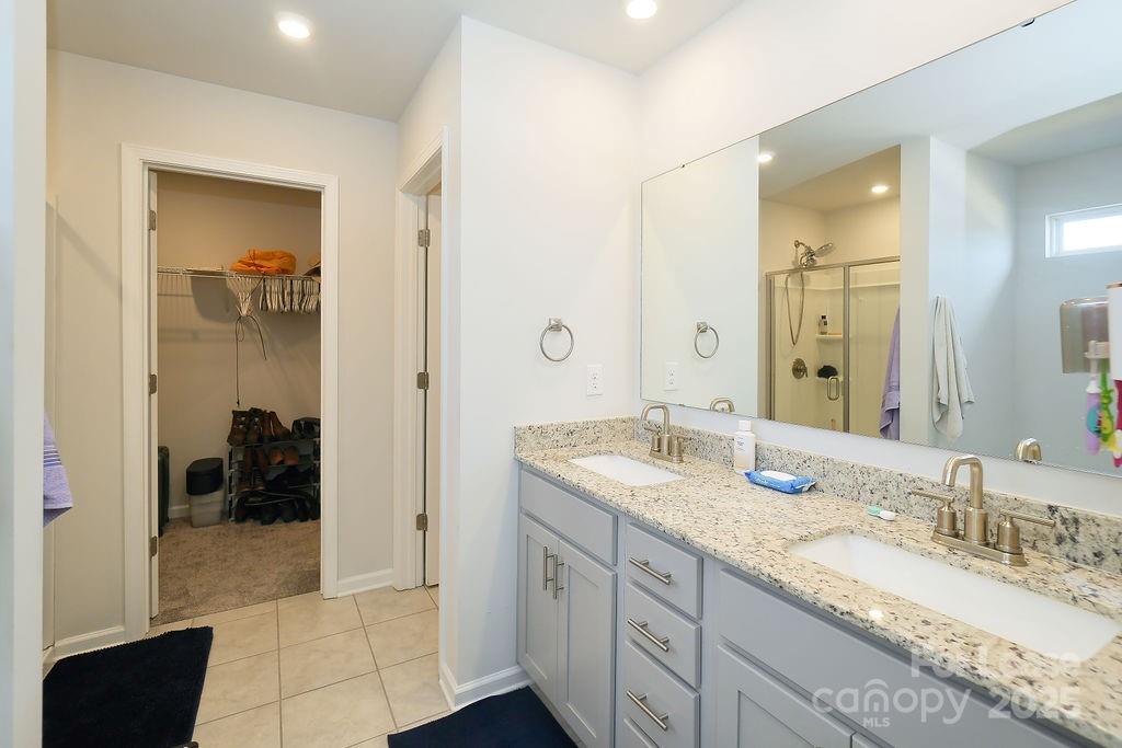 547 Sitka Drive York, SC 29745 - Photo 12 of 20 a spacious bathroom with a granite countertop double vanity sink mirror and shower