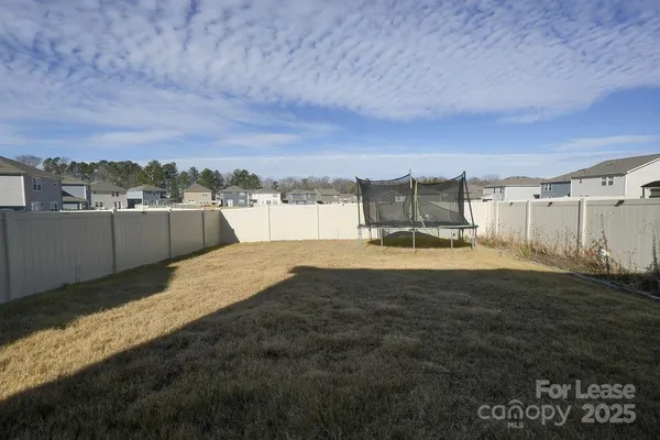 a view of a backyard with furniture and a window