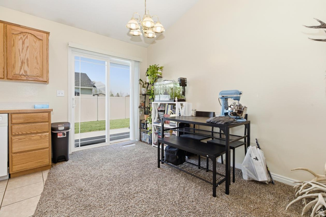 619 East 1st S Street, Unit S Preston, ID 83263 - Photo 7 of 16 Dining area featuring vaulted ceilings, a contemporary chandelier, and sliding glass doors