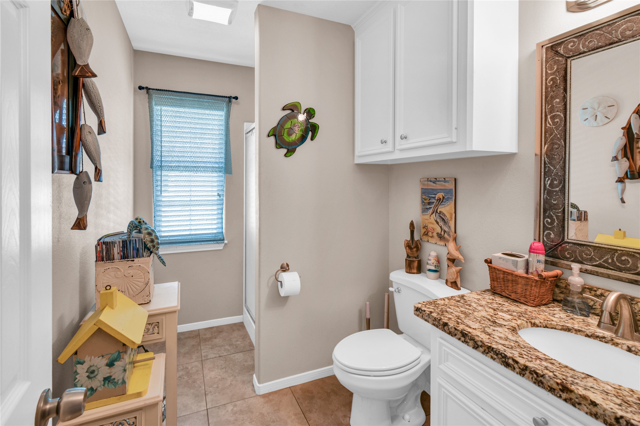 115 Driftwood Road Freeport, TX 77541 - Photo 13 of 21 a bathroom with a granite countertop toilet sink and mirror