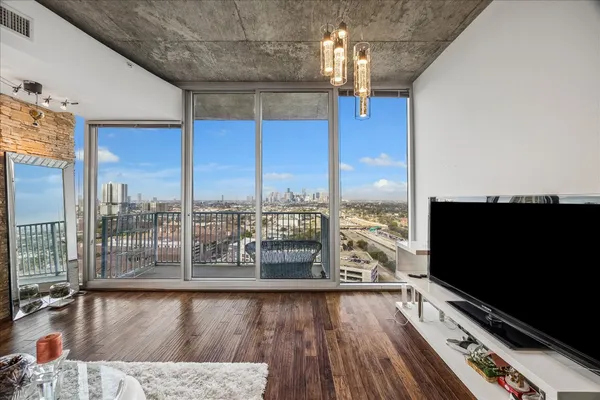 a kitchen with stainless steel appliances granite countertop a sink a stove a microwave a dining table and chairs