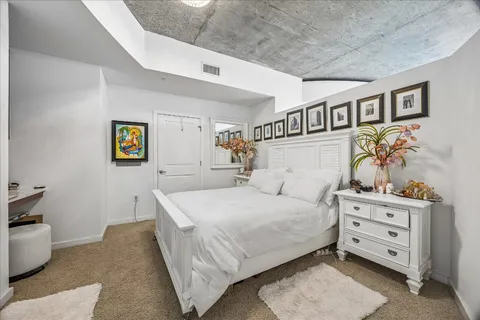 a bedroom with a bed and a dresser