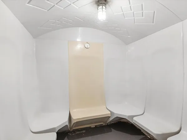 a bathroom with a toilet and a shower