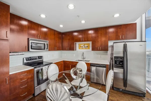 a living room with furniture flat screen tv and a floor to ceiling window