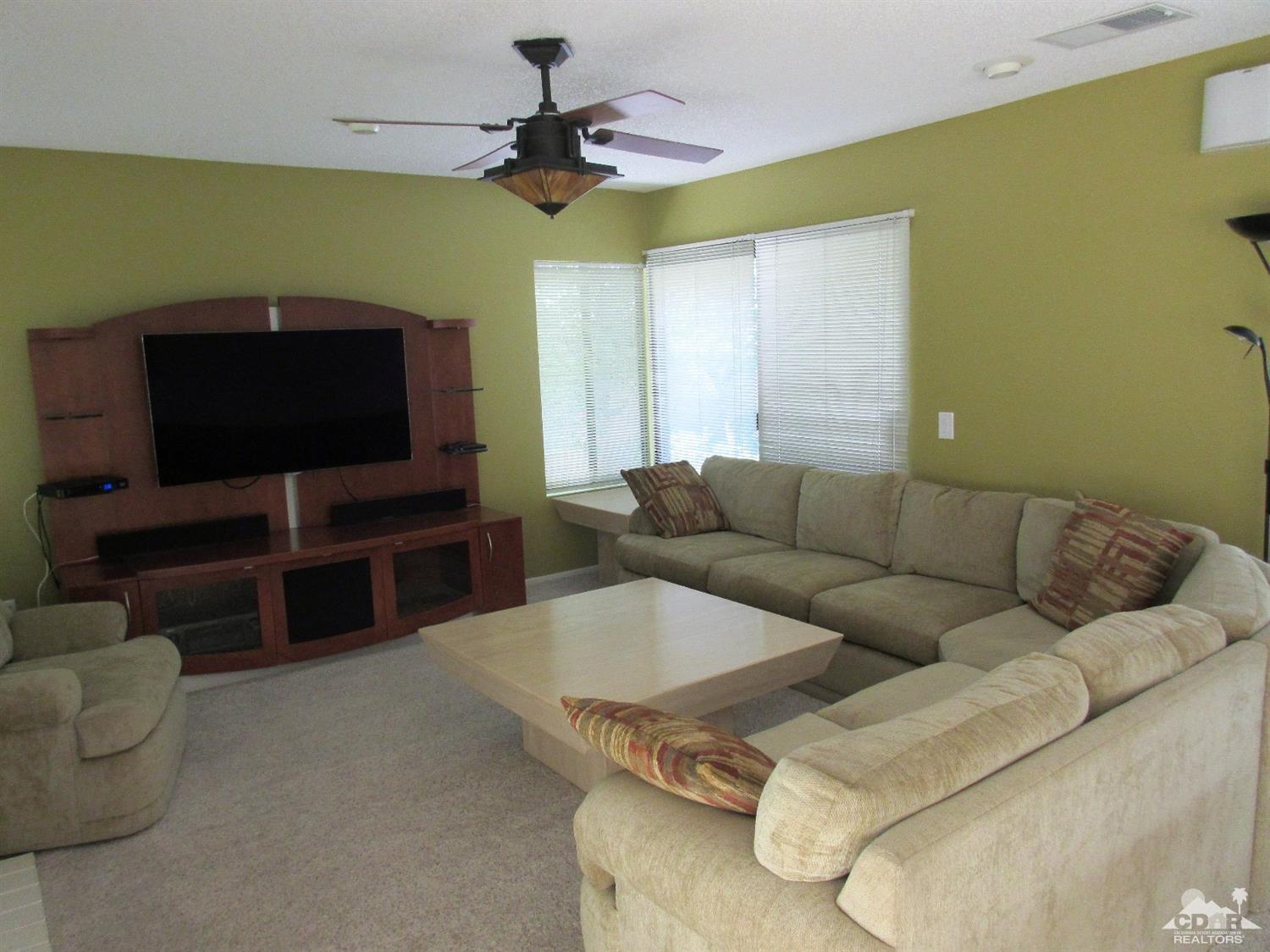 1 Pacifica Lane Palm Desert, CA 92260 - Photo 14 of 22 a living room with furniture and a flat screen tv