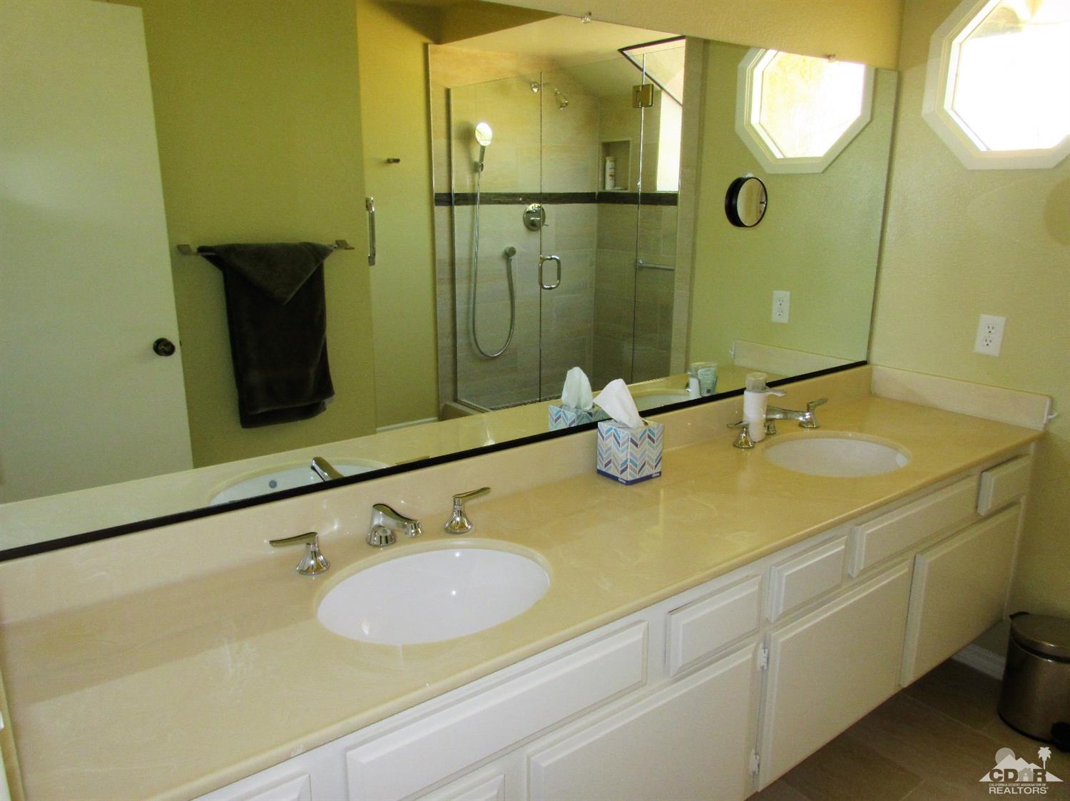 1 Pacifica Lane Palm Desert, CA 92260 - Photo 17 of 22 a bathroom with a sink and mirror