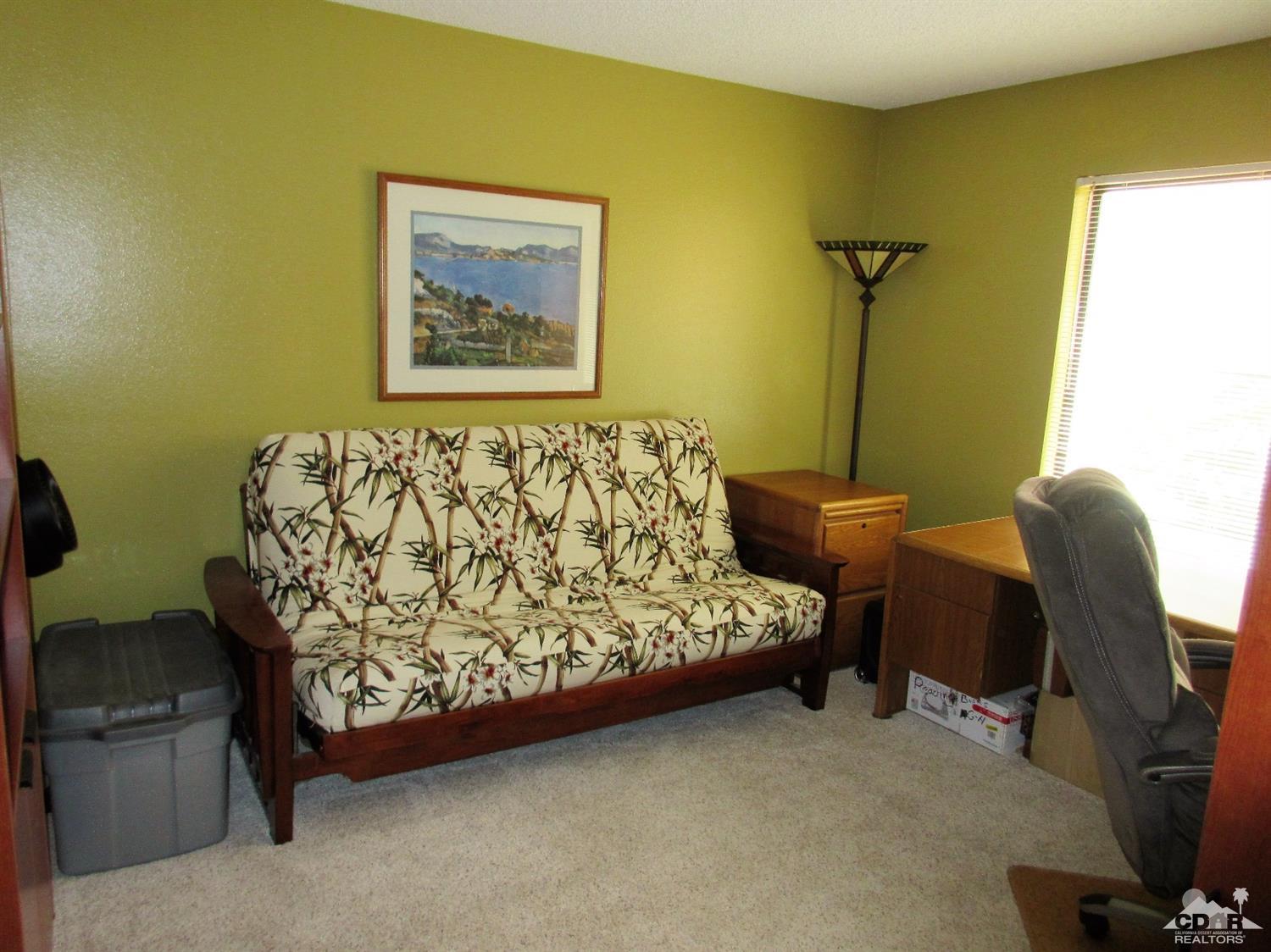 1 Pacifica Lane Palm Desert, CA 92260 - Photo 19 of 22 a bed sitting in a room next to a blue wall