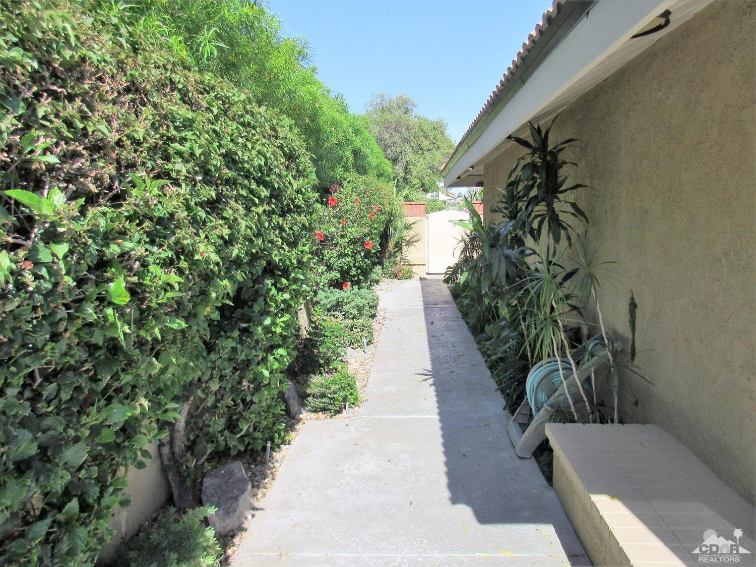 1 Pacifica Lane Palm Desert, CA 92260 - Photo 3 of 22 a view of a backyard with flowers