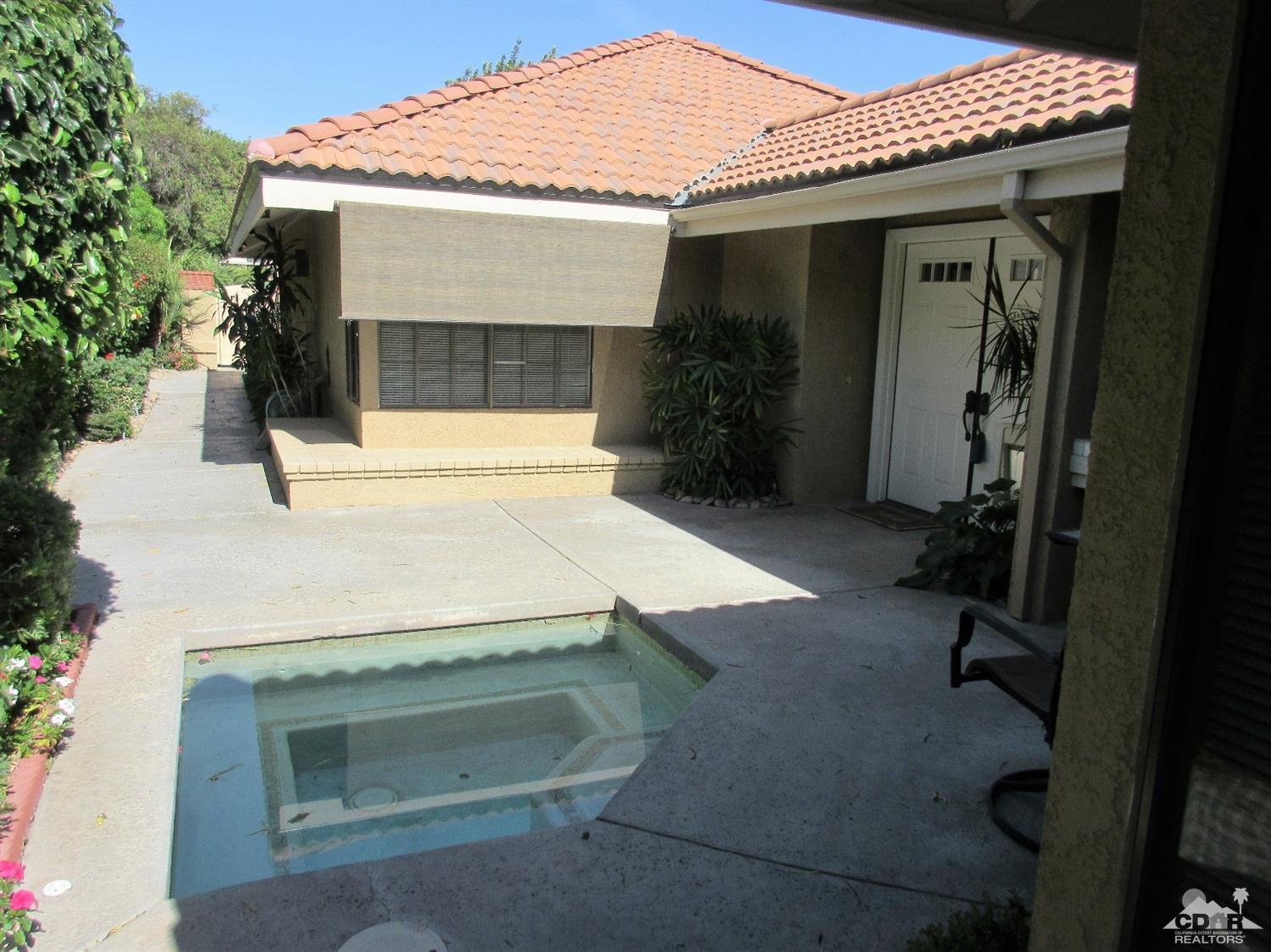 1 Pacifica Lane Palm Desert, CA 92260 - Photo 5 of 22 a front view of a house with a yard