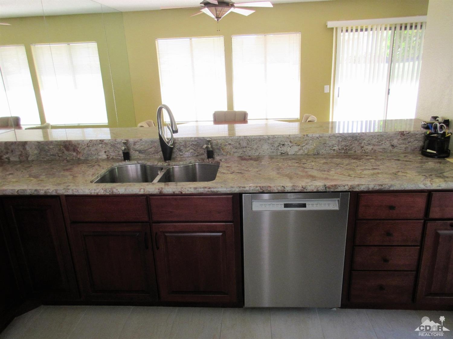 1 Pacifica Lane Palm Desert, CA 92260 - Photo 8 of 22 a kitchen with a sink and a window