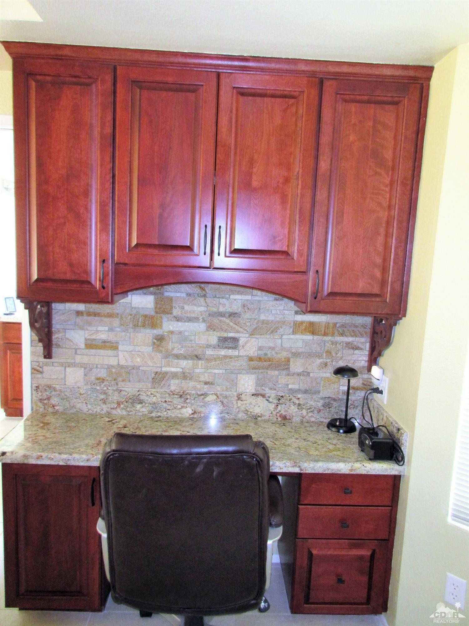 1 Pacifica Lane Palm Desert, CA 92260 - Photo 10 of 22 a kitchen with granite countertop wooden cabinets