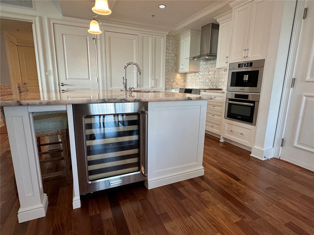 1350 Main Street, Unit 1401 Sarasota, FL 34236 - Photo 11 of 69 a kitchen with kitchen island granite countertop a stove and a sink